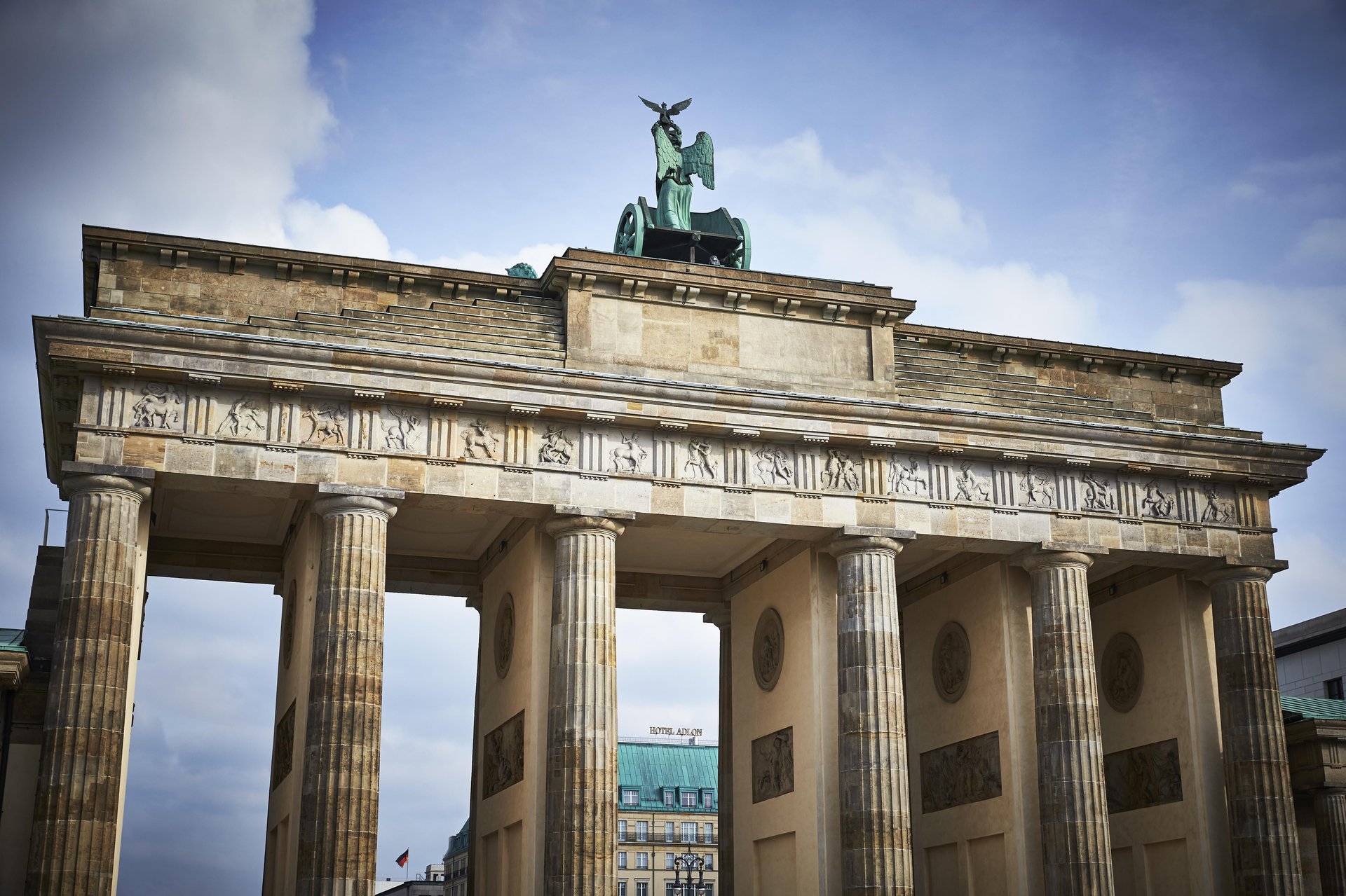 Brandenburg gate with a view of Hotel Adlon Kempinski Berlin