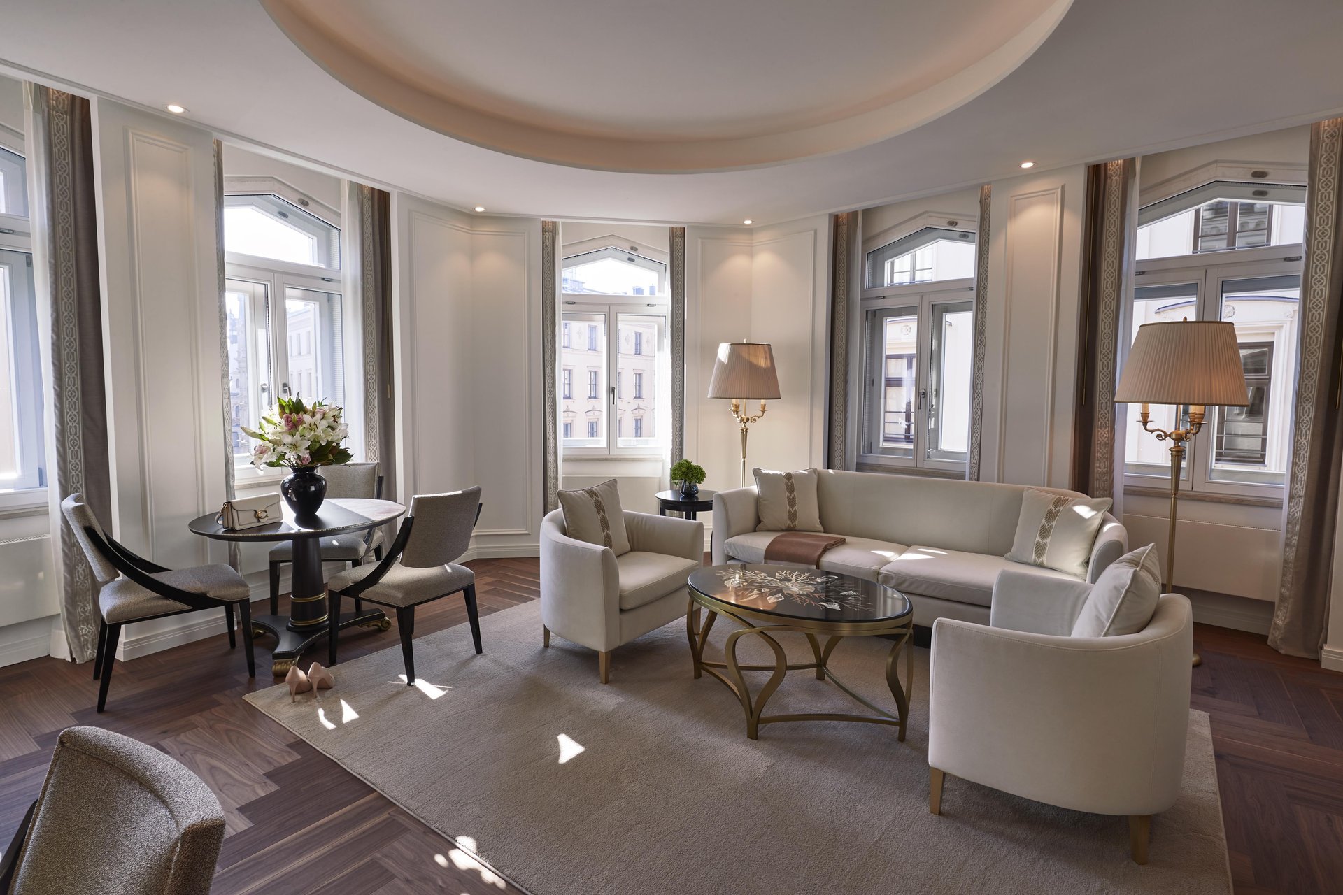 Elegant Signature Two Bedroom Suite living room with floor-to-ceiling windows at Hotel Vier Jahreszeiten Kempinski München