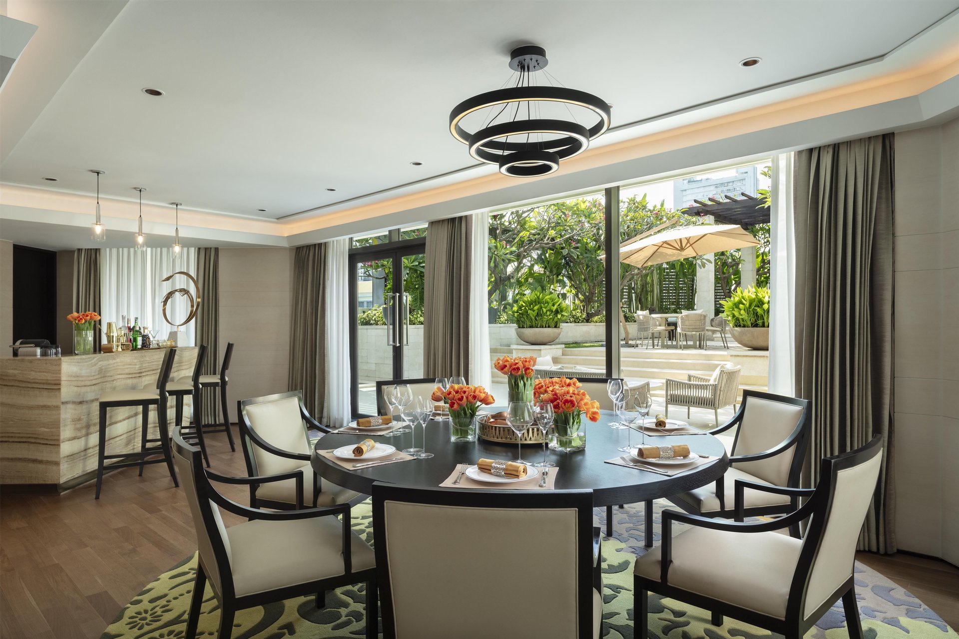 Elegant dining table and private bar in the Terrace Suite at Siam Kempinski Hotel Bangkok.
