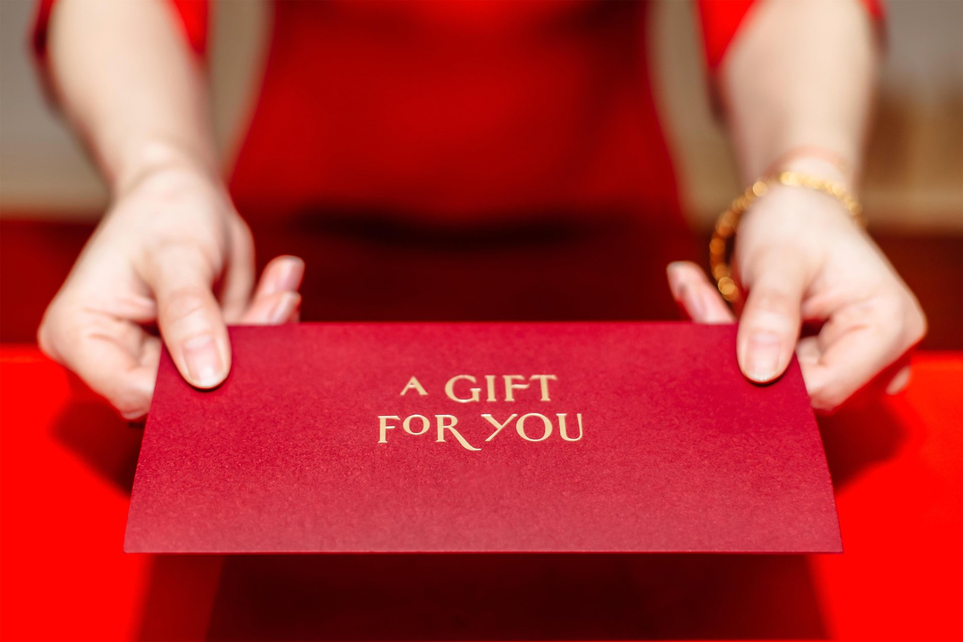 Lady in Red holding a printed red gift certificate