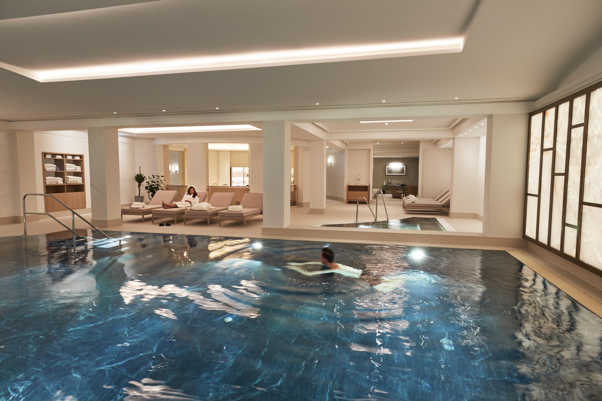 Couple enjoying the luxury indoor pool and relax area at Hotel Adlon Kempinsi Berlin