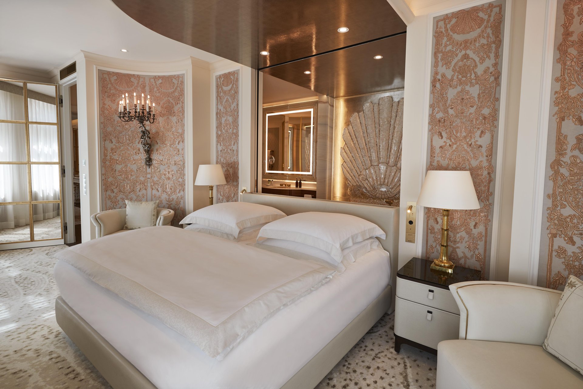 Ludwig Suite master bedroom with gold shell headboard and silk wall panels at Hotel Vier Jahreszeiten Kempinski München