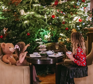 Mother and child in front of a Christmas tree