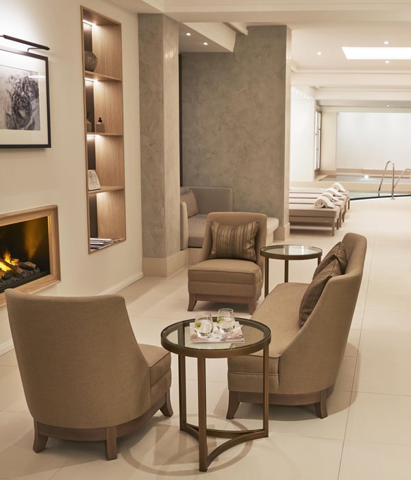 Relax area with fireplace next to the Adlon pool